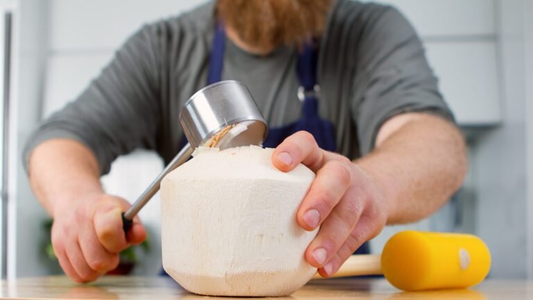 coconuts being cracked open with tools